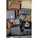 Collection of box cameras including green Kodak Brownie, Coronet 60x6 and Baby Brownie Special. P&