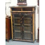 Late Regency period Chinoiserie lacquered two door glazed bookcase with bamboo frame, lacking