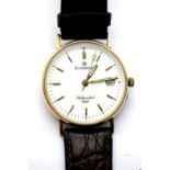 9ct gold sovereign wristwatch on a leather strap, verso lightly engraved, working at lotting, dial