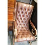 Brown leather button back rocking chair. Not available for in-house P&P.
