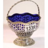 George III hallmarked silver pierced basket, wave edge with Bristol blue glass liner and swing