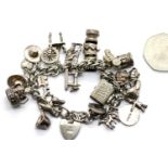 Sterling silver charm bracelet with 22 charms, approximately 84g total weight. Padlock hallmarked
