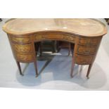 Antique kidney shaped writing desk with leather top brass gallery and inlaid decoration tapering