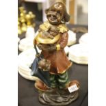 Contemporary bronze clown with dog figurine cold painted and plaster filled, H: 44 cm. This lot is