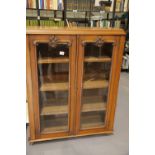Victorian twin door glazed bookcase with carved decoration, 24 x 94 x 120 cm H. Not available for