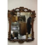 Carved walnut framed antique mirror, 85 x 46 cm. Not available for in-house P&P