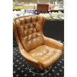 Faux leather rocking armchair on a circular swivel base. Not available for in-house P&P