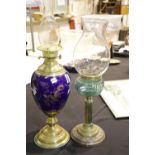 Ceramic and brass gilt decorated paraffin lamp plus another, tallest H: 70 cm. Not available for
