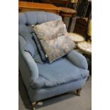 Early 20th century blue upholstered armchair with overstuffed seat and back cushion. Not available