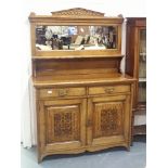 Arts and Crafts Golden Oak mirror back sideboard having carved cupboard doors and two short drawers.