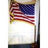 20th century American flag having 50 stars, gold fringed and raised on a brass mounted flagpole