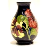 Moorcroft blue ground vase in the Hibiscus pattern. P&P Group 2 (£18+VAT for the first lot and £3+