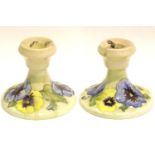 Moorcroft cream ground pair of Pansy candlesticks. P&P Group 2 (£18+VAT for the first lot and £3+VAT