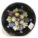 Moorcroft blue ground footed bowl in the Pansy pattern, D: 11 cm. P&P Group 1 (£14+VAT for the first