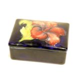 Moorcroft blue ground lidded box in the Hibiscus pattern 7 x 10 cm. P&P Group 1 (£14+VAT for the