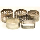 Two Art Deco hallmarked silver napkin rings, a white metal presumed silver napkin ring and two