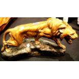 Large cast plaster Lion on a rock, H: 52 cm, signed T. Cartier. P&P Group 3 (£25+VAT for the first