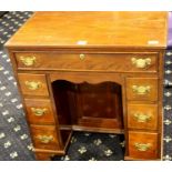 George III mahogany kneehole desk, the central inset cupboard flanked by two banks of drawers,