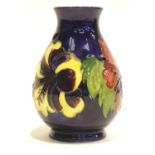 Moorcroft blue ground bulbous vase in the Hibiscus pattern, H: 13 cm. P&P Group 1 (£14+VAT for the