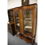 Large Edwardian inlaid mahogany display cabinet with serpentine front and curved glass, two