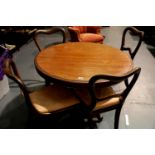 Victorian walnut tilt top breakfast table with a carved tripartite base, D: 103 cm with a set of