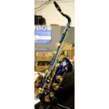 Stagg 77/ST tenor saxophone in blue with mother of pearl buttons, together with saxophone stand