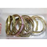 Box of yellow metal bangles. P&P Group 1 (£14+VAT for the first lot and £1+VAT for subsequent lots)