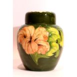 Moorcroft ceramic ginger jar in the Coral Hibiscus pattern, signed to base, H: 15 cm. P&P Group