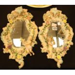 Pair of Sitzendorf floral wall mirrors, H: 48 cm. Not available for in-house P&P.