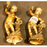 A pair of 19th century bronze figures of young boys holding torches, each lacking base and one