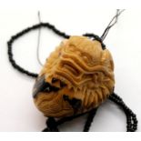 Vintage hand carved tagua nut Dragonball netsuke on beaded cord. P&P Group 1 (£14+VAT for the