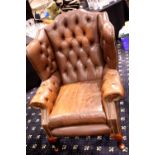 Brown leather button back Chesterfield style armchair. Not available for in-house P&P. Condition