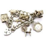 Hallmarked silver charm bracelet, with seven charms. 40g L:22 cm P&P Group 1 (£14+VAT for the