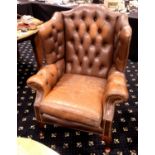 Brown leather button back Chesterfield style armchair. Not available for in-house P&P.