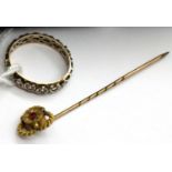 9ct gold, ruby set tie pin and an unmarked white metal set with stones, testing as diamonds. Size J.