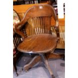 Early 20thC elm desk chair on height adjustable swivel base, H: 85 cm. Not available for in-house