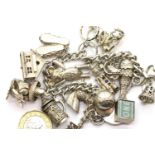 Heavy hallmarked silver charm bracelet with fifteen charms, L: 22 cm, 102g. P&P Group 2 (£18+VAT for