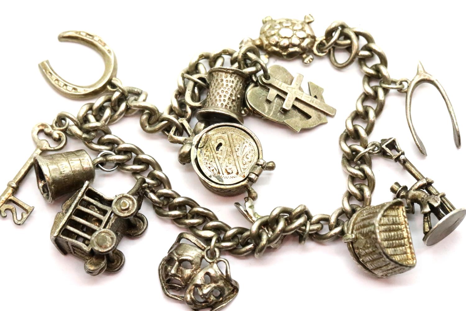 Silver charm bracelet with 13 charms, L: 16 cm, 45g. P&P Group 1 (£14+VAT for the first lot and £1+