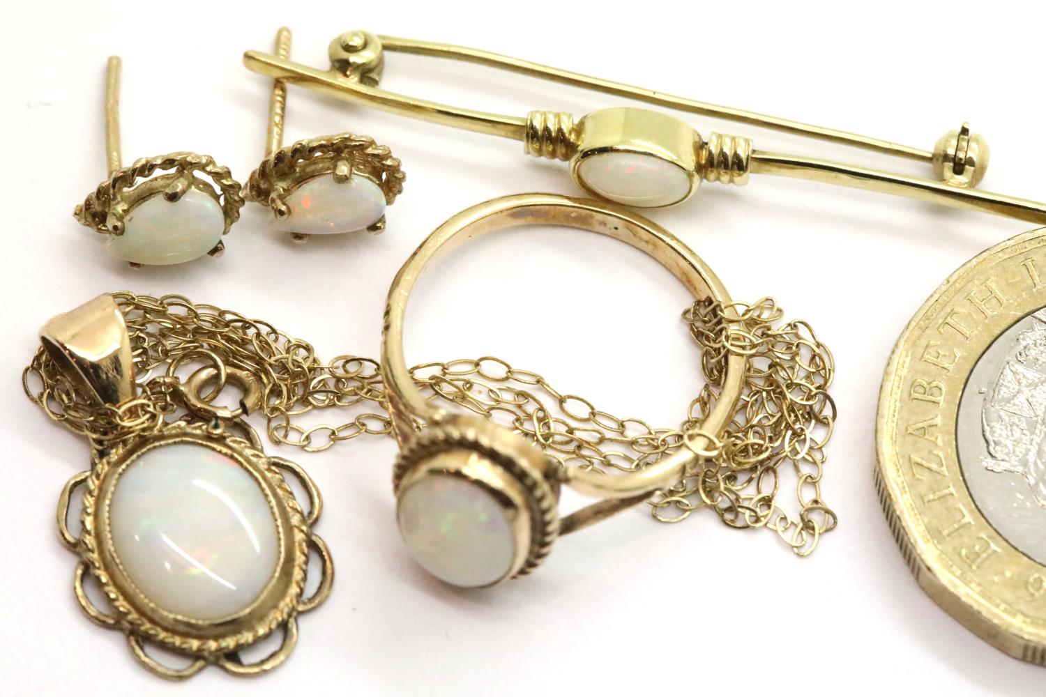 9ct gold suite of opal jewellery comprising a pendant, brooch, ring and earrings. P&P Group 1 (£14+