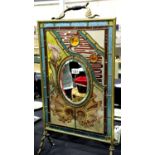 Late Victorian stained and leaded glass fire screen, having an oval bevelled mirror insert and brass