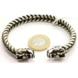 White metal Tibetan silver twisted bangle with dragon head terminals. P&P Group 1 (£14+VAT for the