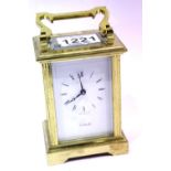 Brass carriage clock by Cottrills with key, having visible escapement. P&P Group 2 (£18+VAT for