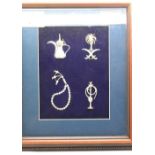 Framed display of Middle-Eastern silver miniatures. P&P Group 1 (£14+VAT for the first lot