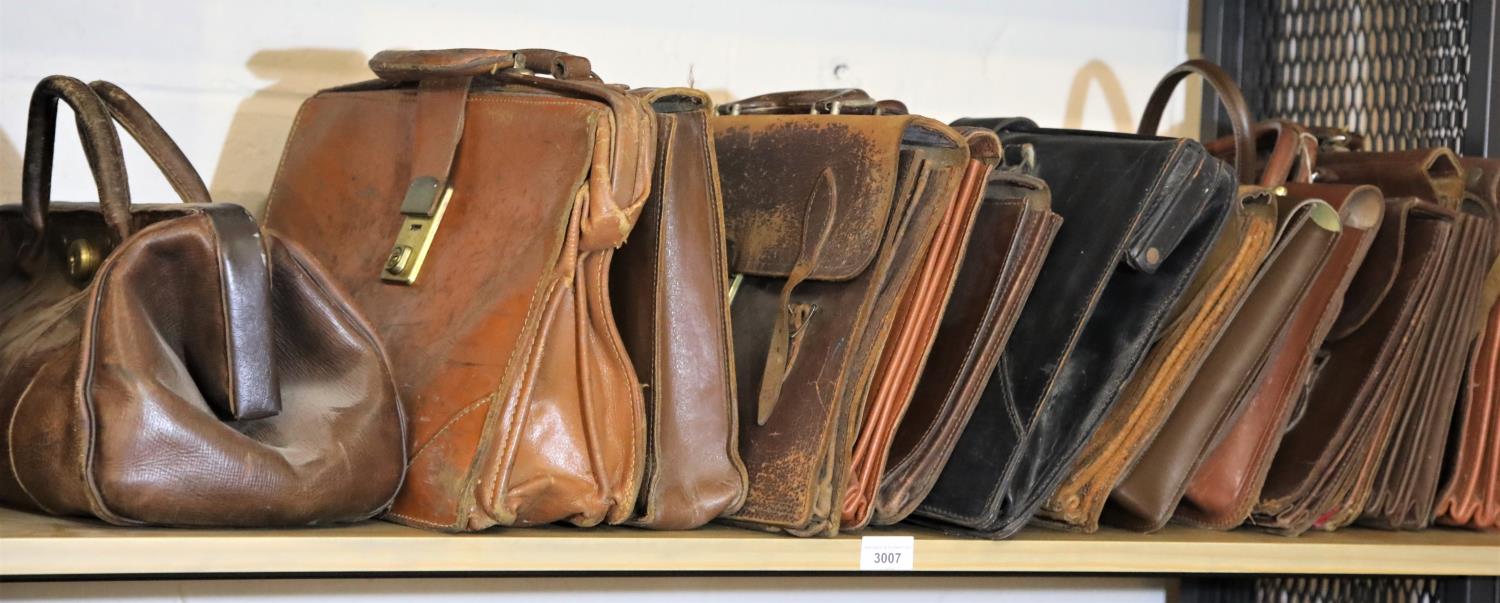 Fourteen vintage leather briefcases. Not available for in-house P&P