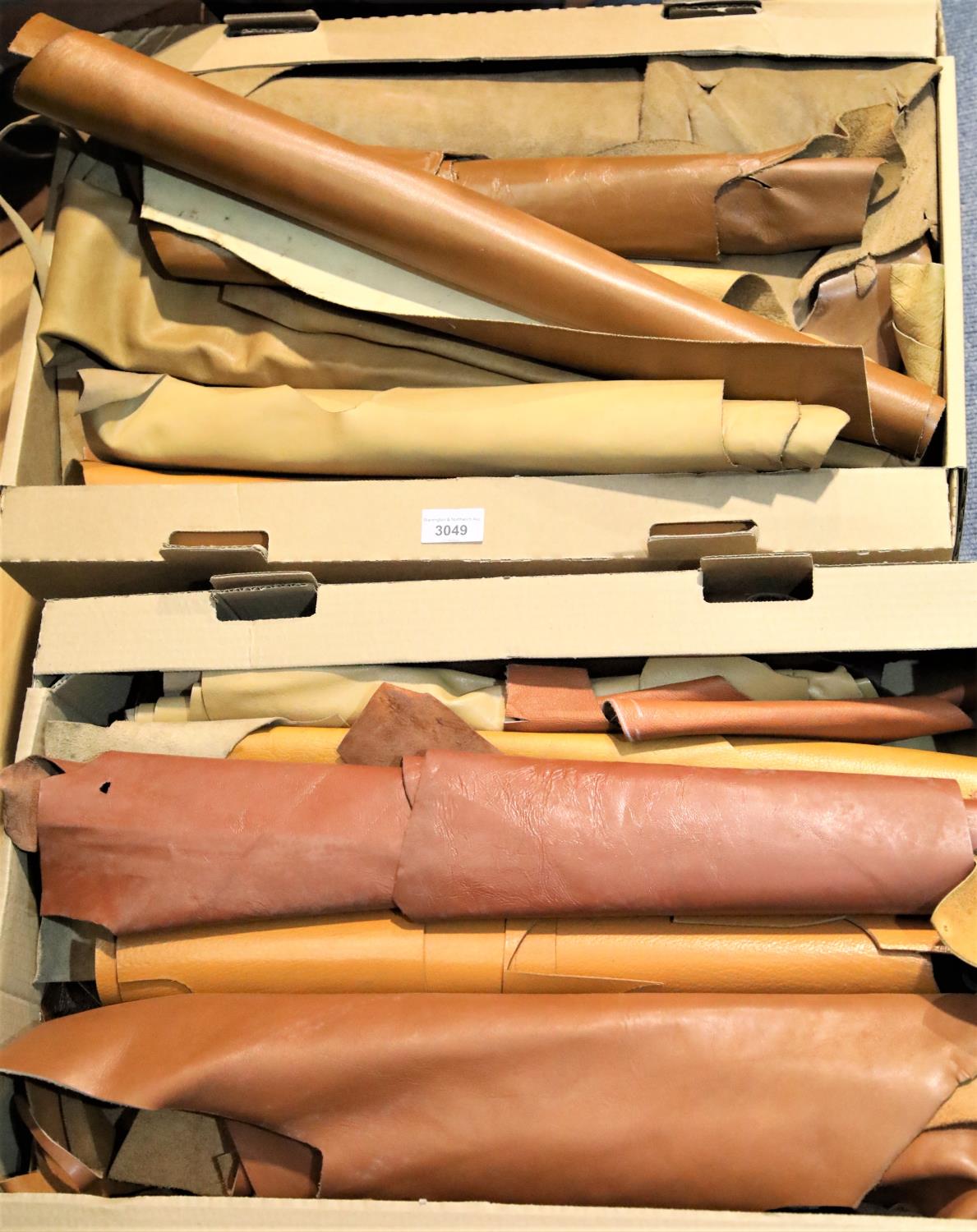 Two boxes of brown leather pieces and quantity of rolled brown leather. Not available for in-house