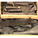 Two boxes of black leather pieces. P&P Group 3 (£25+VAT)