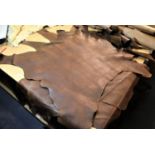 Three small full and one part brown leather part hides. P&P Group 3 (£25+VAT)