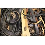 Two boxes of black and brown leather belt lengths, holed but without buckles. Not available for in-