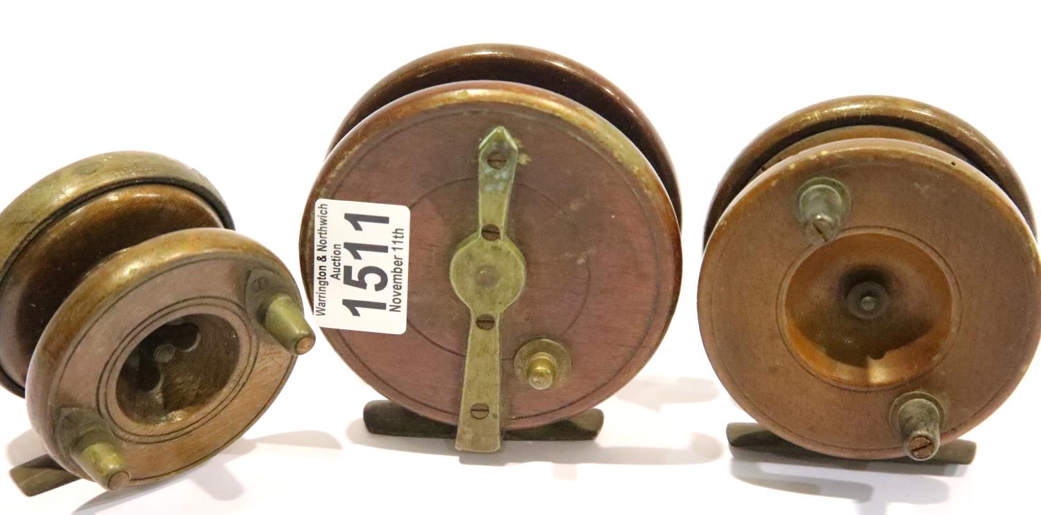 Three wood and brass centre pin fishing reels, two marked Made in England, one S Allcock & Co. P&P