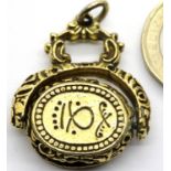 Yellow metal spinning fob with Arabic inscription, 14.5g. P&P Group 1 (£14+VAT for the first lot and